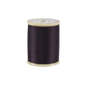 Spool of black thread on a white background