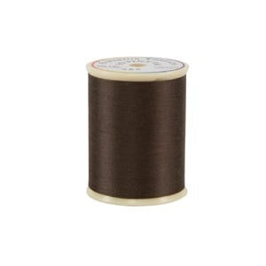 Spool of brown thread on a white background