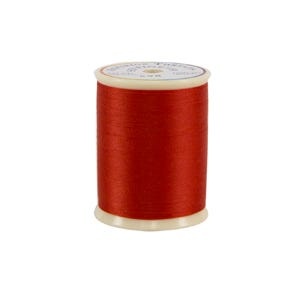 Spool of red thread on a white background