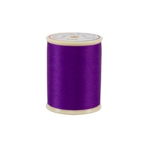 Spool of purple thread on a white background