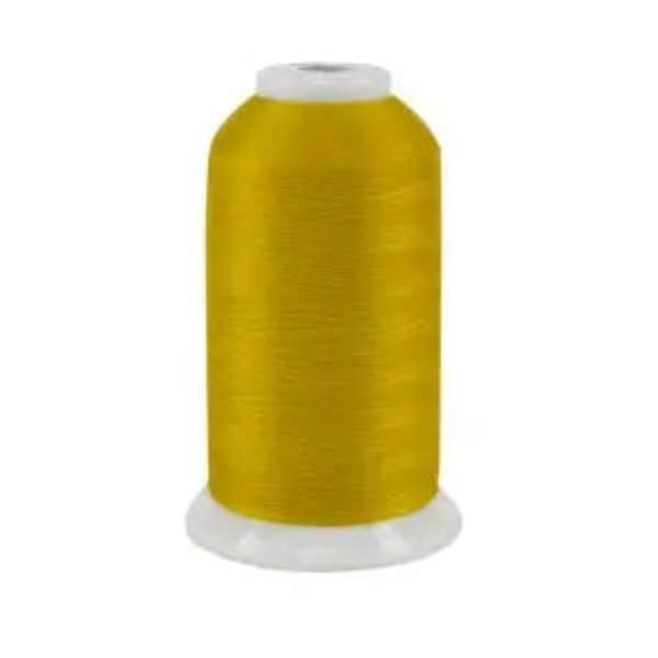 Spool of yellow thread on a white background
