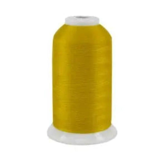 Spool of yellow thread on a white background