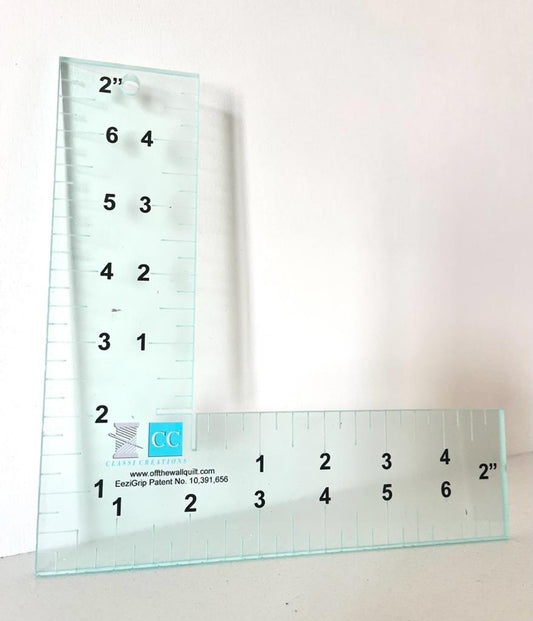 Two glass rulers with measurement markings on a white background