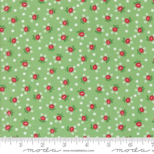Fabric with red and white floral pattern on a green background, featuring Moda label.