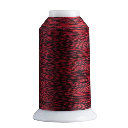 Spool of red and black thread on a white background