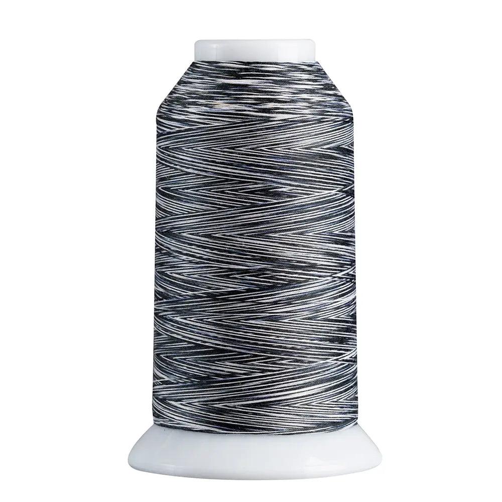 Spool of black and white thread on a white background