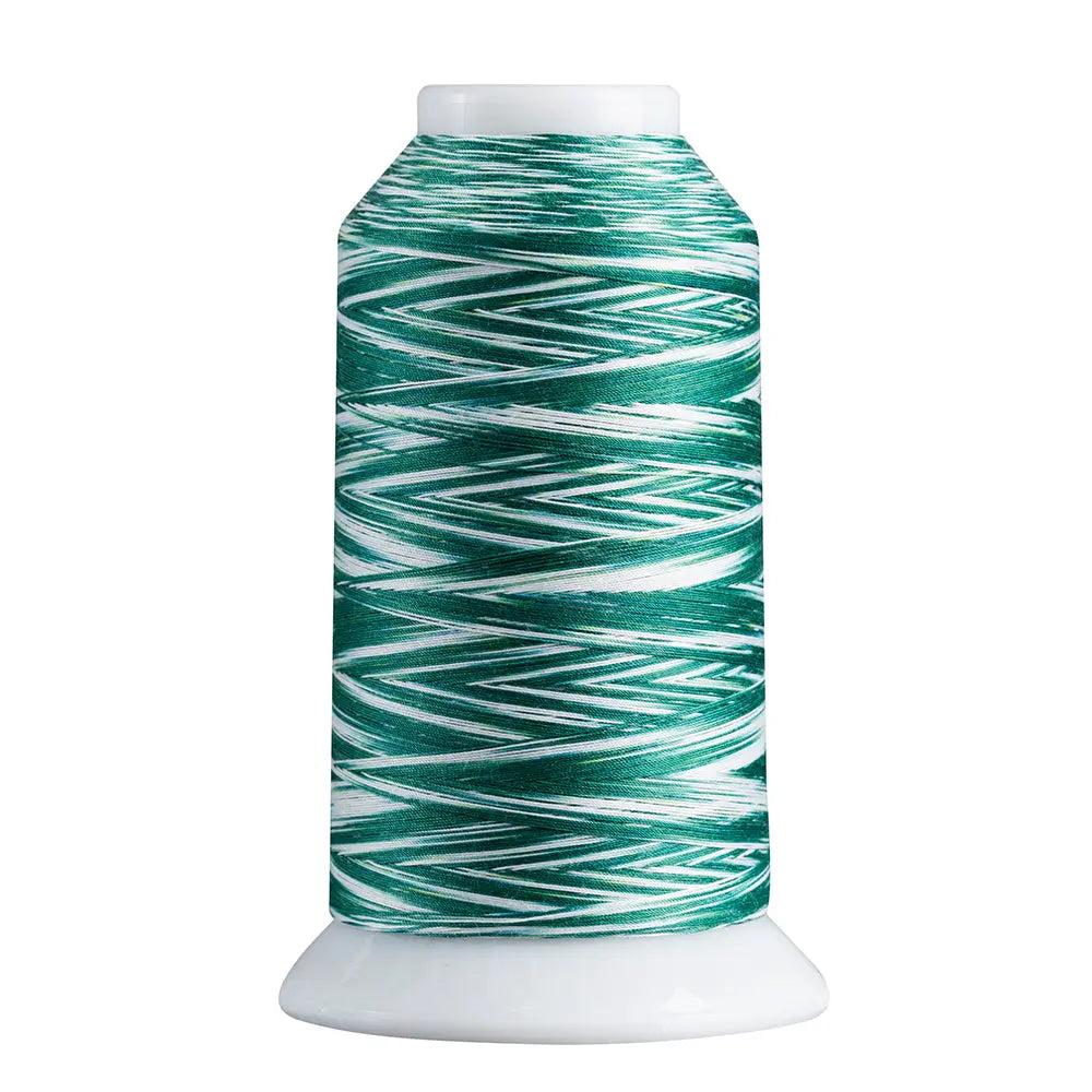 Spool of green and white thread on a white background