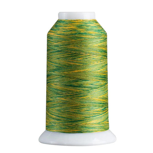 Spool of green and yellow thread on a white background
