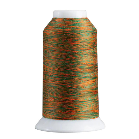 Spool of green and orange thread on a white background