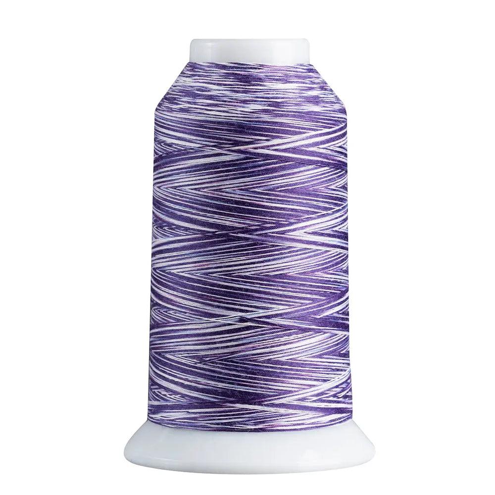 Spool of purple and white thread on a white background