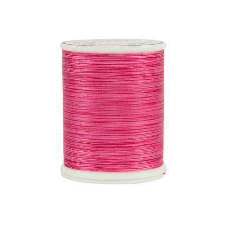 Spool of pink thread on a white background
