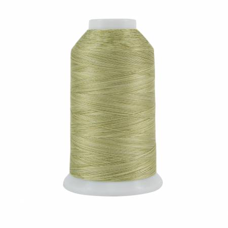 Spool of green thread on a white background
