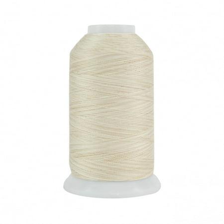 Spool of beige thread on a white background