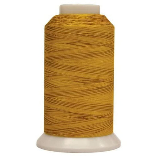 Spool of yellow thread on a white background