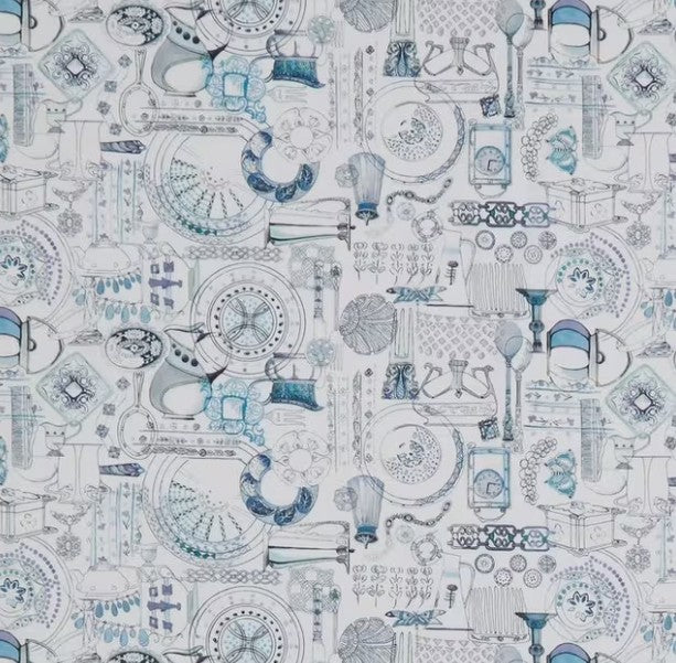 Patterned fabric with blue and gray designs on a white background