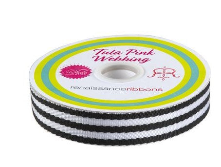 Spool of Tula Pink webbing with black and white stripes on a white background