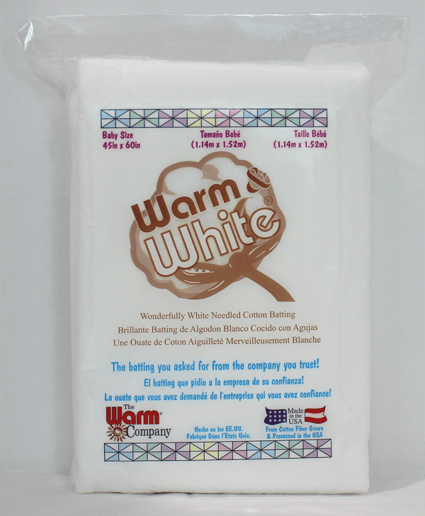 Package of Warm & White baby size cotton batting with branding and text on a white background