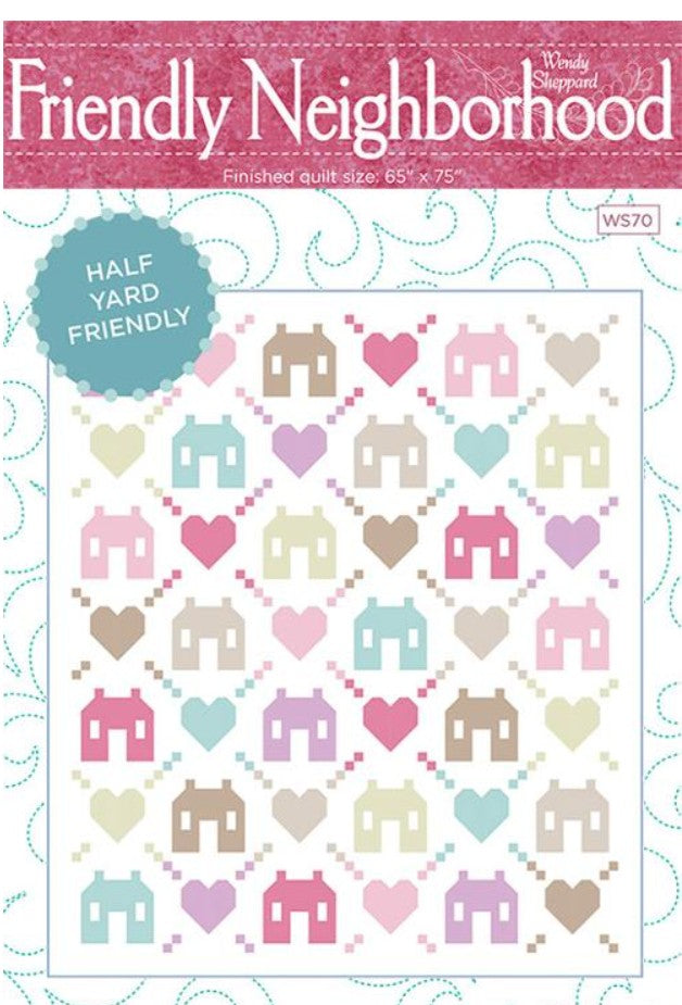 Quilt pattern with houses and hearts on a white background, labeled 'Friendly Neighborhood'.