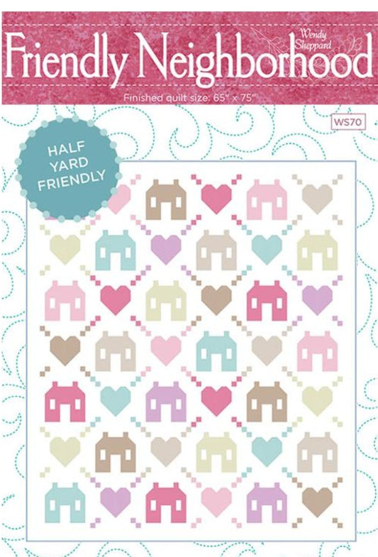 Quilt pattern with houses and hearts on a white background, labeled 'Friendly Neighborhood'.