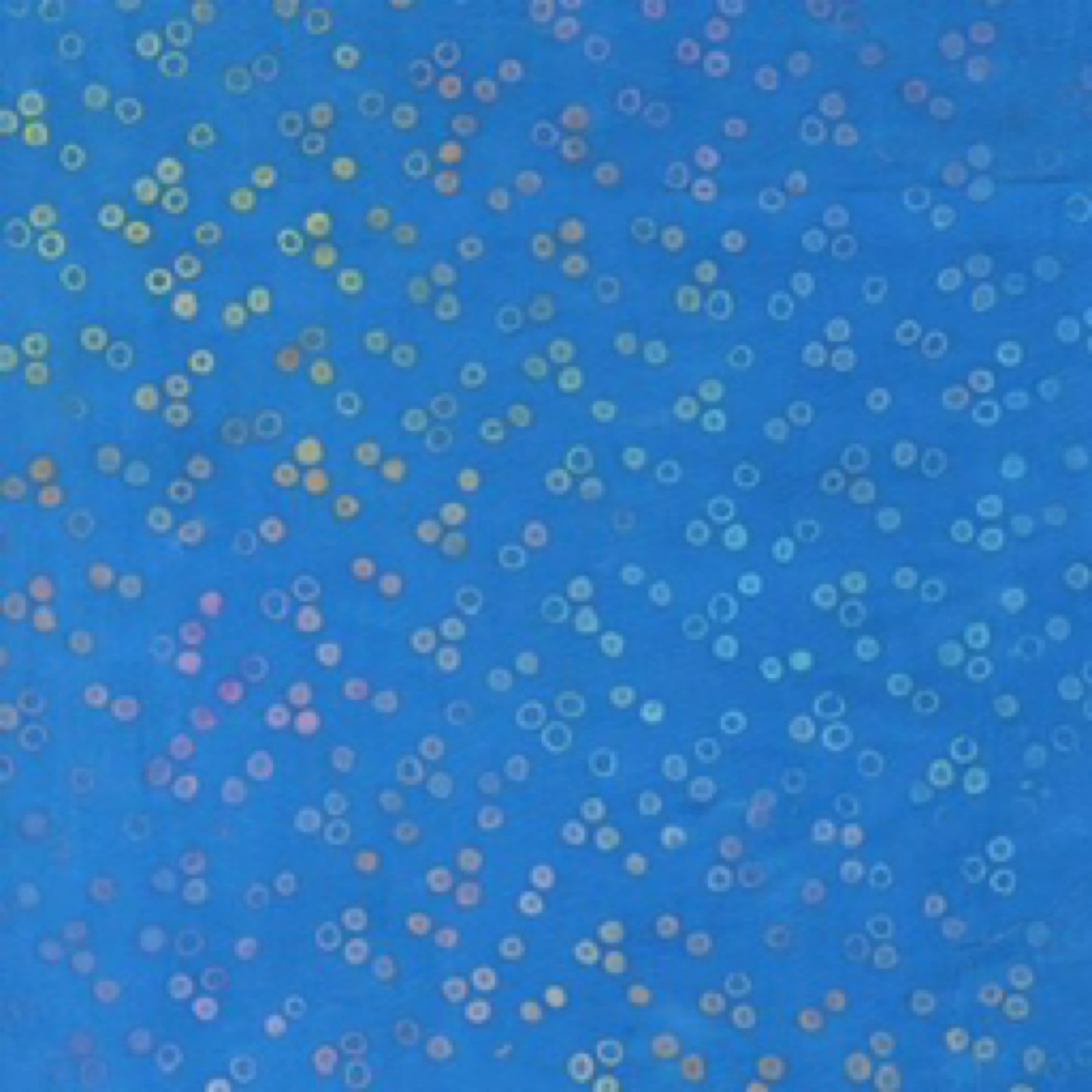 Blue fabric with small multicolored circles pattern